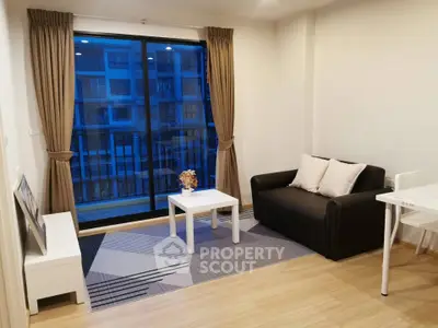 Modern living room with cozy sofa and large window offering city view