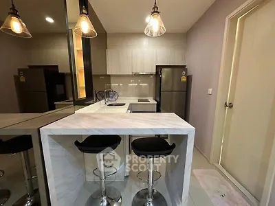 Modern kitchen with sleek breakfast bar and stylish pendant lighting