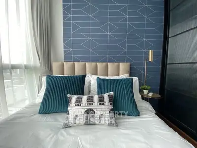 Modern bedroom with stylish blue accent wall and plush pillows