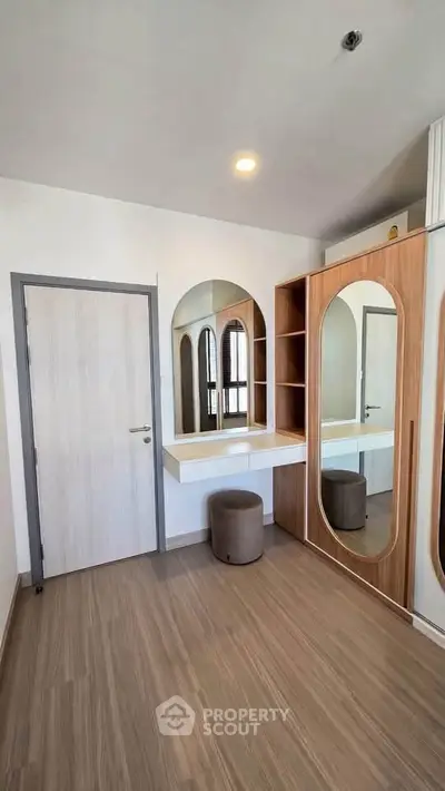 Modern bedroom with stylish wooden furniture and large mirrors, perfect for a contemporary lifestyle.