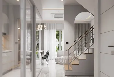 Modern open-plan living area with elegant staircase and stylish dining space.