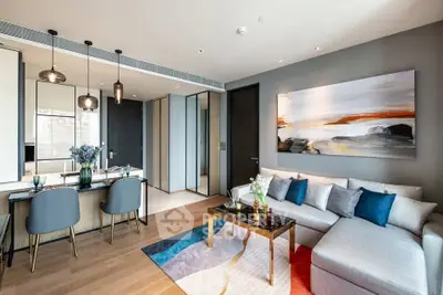 Modern living room with stylish decor and open dining area in a contemporary apartment.