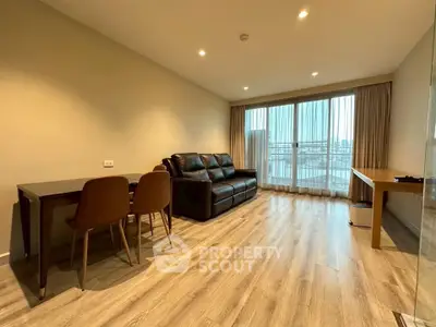 Spacious living room with modern decor and large windows offering city views.