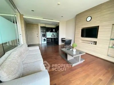 Modern living room with wooden flooring and open kitchen layout