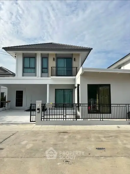 Modern two-story house with sleek design and spacious driveway