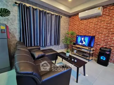 Modern living room with leather sofa, TV, and air conditioning in stylish apartment.
