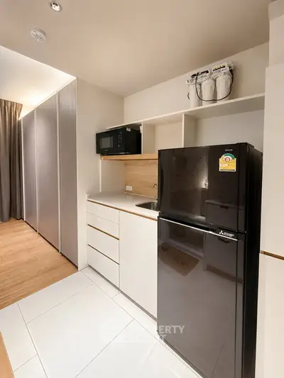 Modern kitchen with sleek appliances and minimalist design in a contemporary apartment.