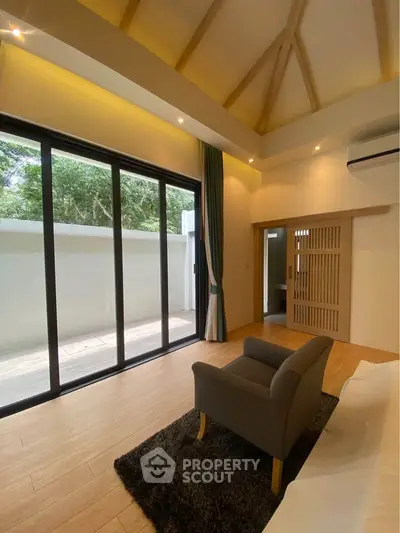 Spacious bedroom with large windows and modern design