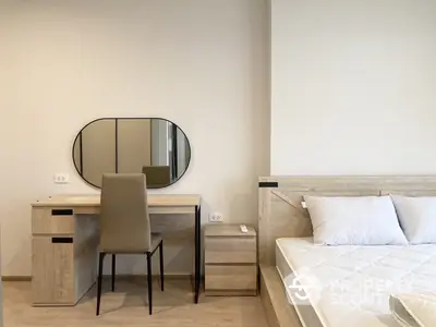 Elegant bedroom with modern furniture, featuring a sleek study desk, comfortable bed, and a stylish oval mirror, ideal for contemporary living.