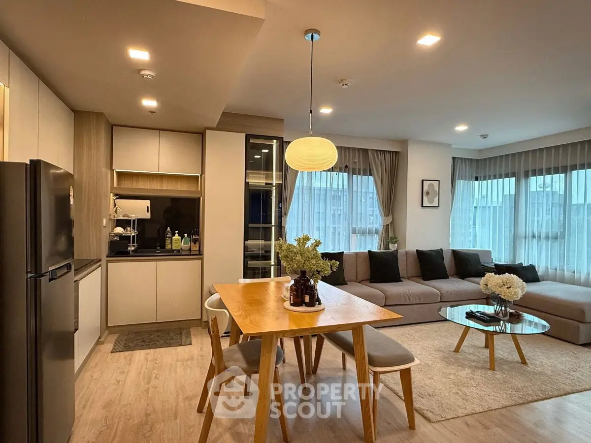 Modern open-plan living room with stylish kitchen and cozy dining area.