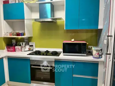 Modern kitchen with vibrant blue cabinets and built-in oven