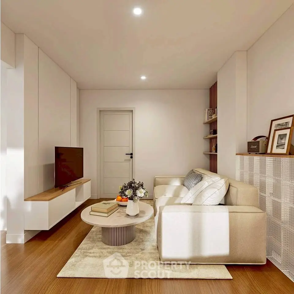 Modern living room with cozy beige sofa, stylish decor, and sleek TV setup in a bright, inviting space.