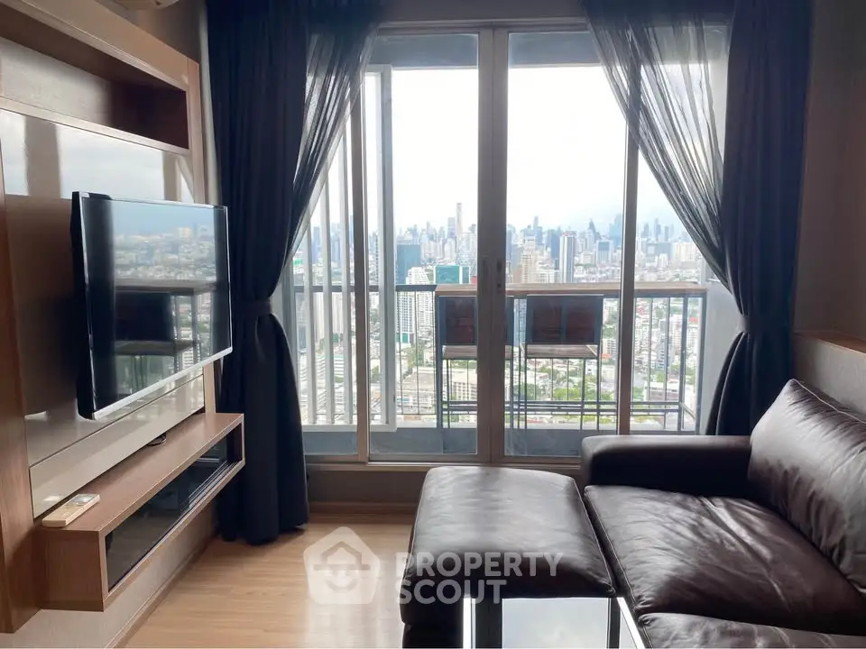 Luxurious living room with stunning city view from high-rise apartment balcony.