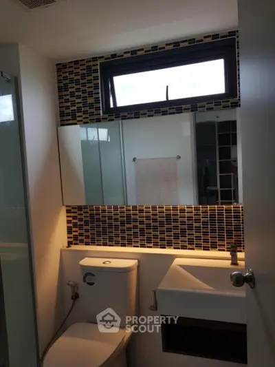 Modern bathroom with stylish mosaic tiles and sleek fixtures