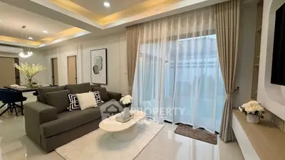 Modern living room with elegant decor and large windows for natural light
