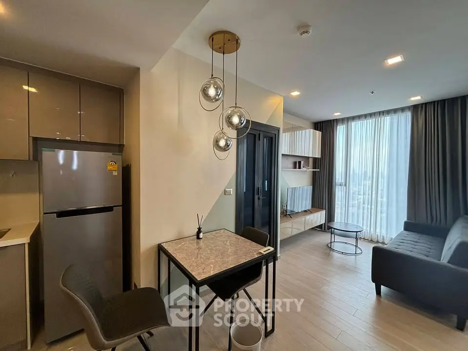 Modern living room with stylish decor and open kitchen layout in a contemporary apartment.