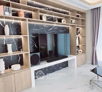 Luxurious living room with modern entertainment center and elegant decor