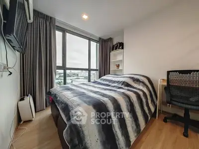 Cozy modern bedroom with large window and stylish decor