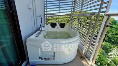 Luxurious balcony with private jacuzzi and stunning green view, perfect for relaxation and leisure.