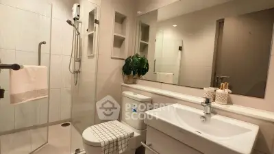 Modern bathroom with glass shower, sleek fixtures, and stylish decor