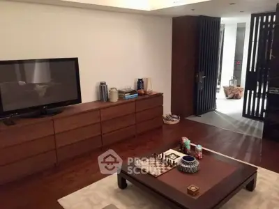 Stylish living room with modern decor and entertainment setup in luxury apartment.