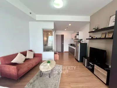 Modern living room with stylish decor and open kitchen layout in a cozy apartment.