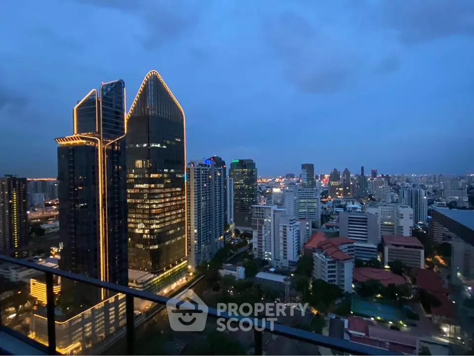Stunning city skyline view from a high-rise balcony at dusk, showcasing illuminated skyscrapers.