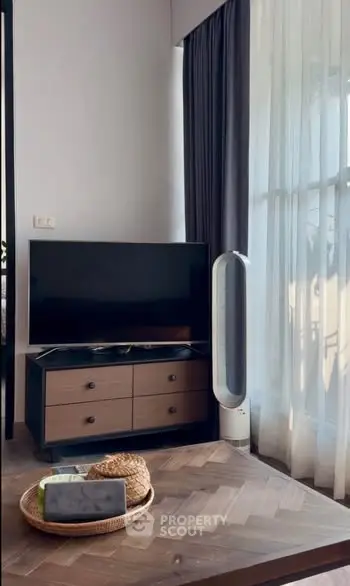 Stylish living room with modern TV stand and elegant curtains