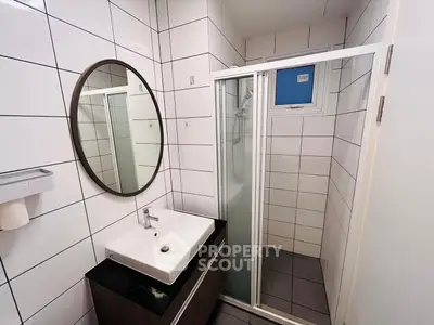 Modern bathroom with sleek sink and glass shower enclosure