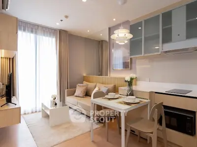 Modern living room with cozy sofa, dining area, and sleek kitchen in open layout apartment.
