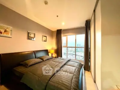 Cozy bedroom with large window offering stunning city views, modern decor, and ample natural light.