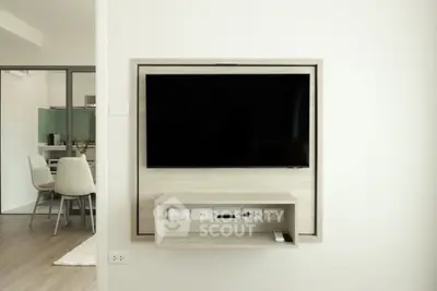 Modern living room with wall-mounted TV and dining area in open layout