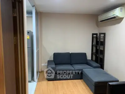 Cozy living room with modern sofa and air conditioning in a compact apartment