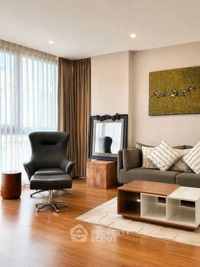 Stylish modern living room with elegant furniture and large windows for natural light.