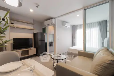 Modern living room with open kitchen and cozy bedroom in stylish apartment