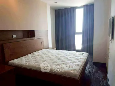 Cozy bedroom with large window and modern furnishings