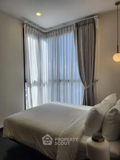 Modern bedroom with large windows and elegant curtains