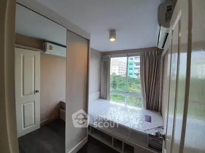 Cozy bedroom with large window and mirrored closet in modern apartment