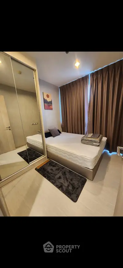 Modern bedroom with mirrored wardrobe and cozy decor