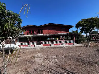 Charming rustic wooden house with spacious porch and lush greenery