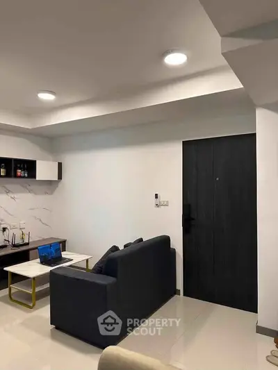 Modern living room with sleek furniture and stylish decor, perfect for urban living.