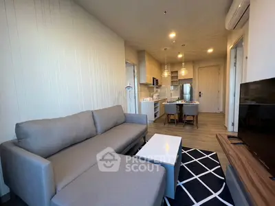 Modern living room with cozy sofa and open kitchen layout