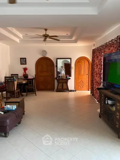 Spacious living room with elegant wooden doors and modern decor