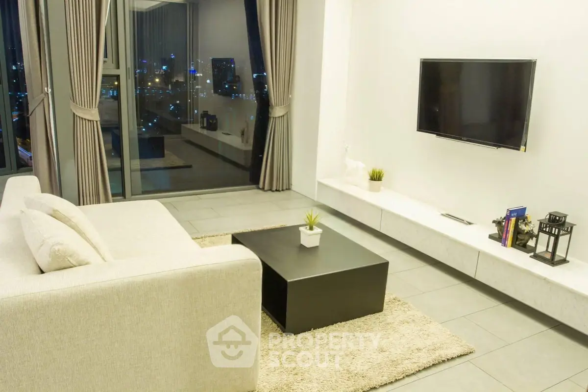 Modern living room with city view, sleek furniture, and wall-mounted TV