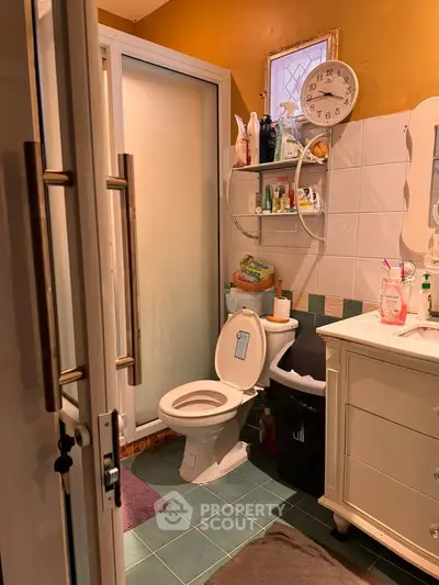 Cozy bathroom with modern shower and stylish decor, perfect for a compact home.