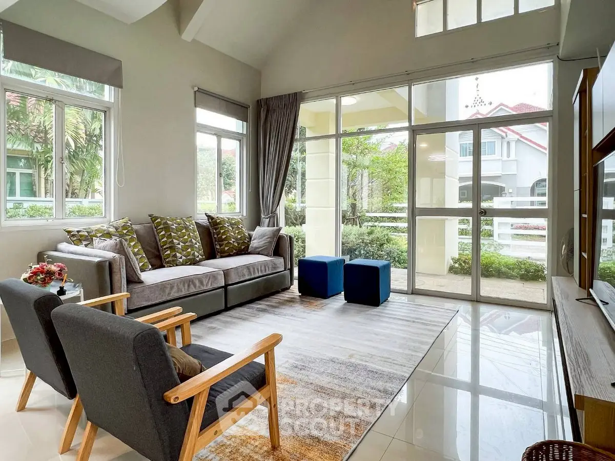 Spacious living room with large windows and modern furniture