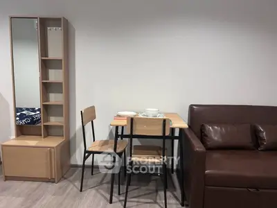 Cozy living room with modern furniture and dining area in a stylish apartment.