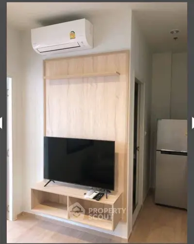 Modern living room with wall-mounted TV and air conditioning unit