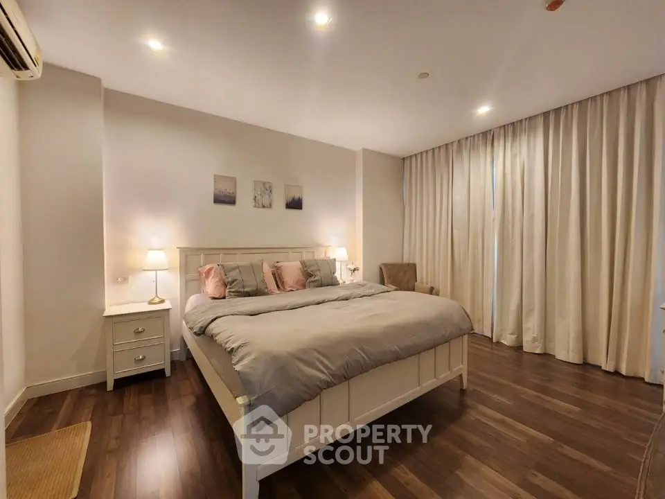 Spacious and cozy bedroom with elegant decor and soft lighting, perfect for relaxation.