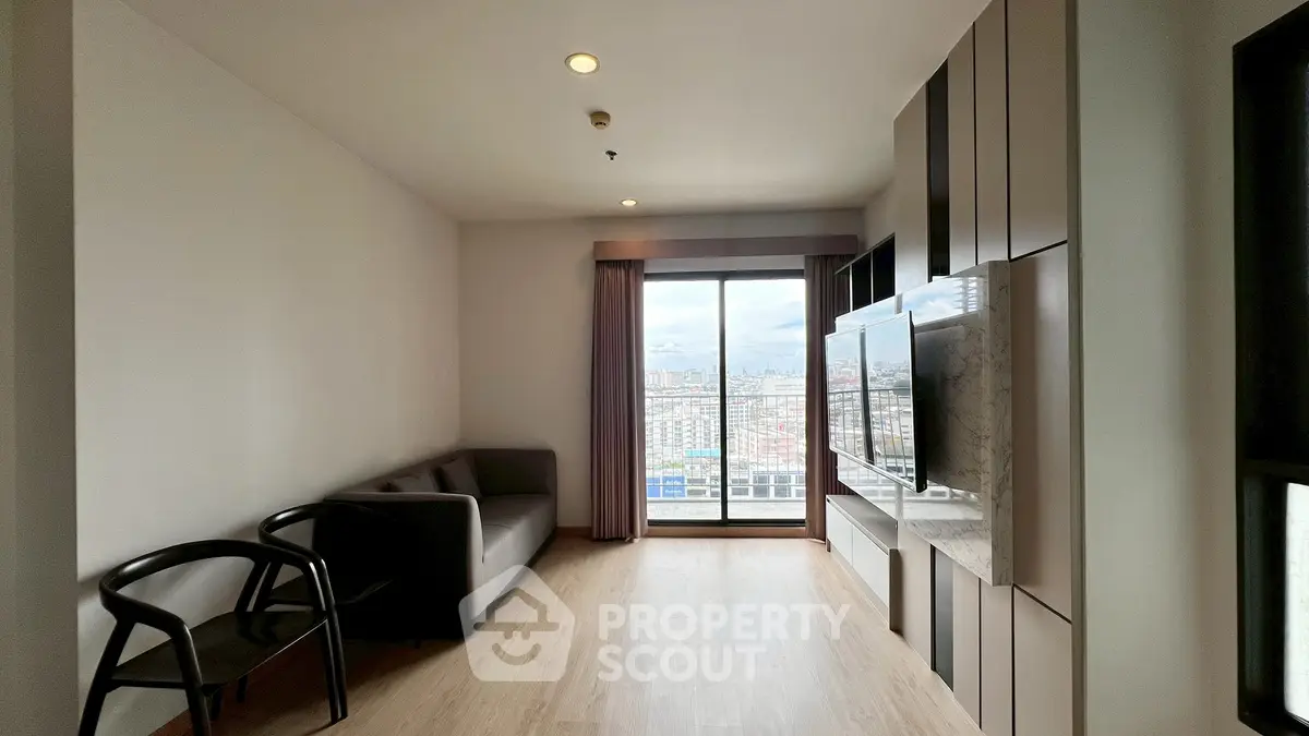 Modern living room with city view, featuring sleek furniture and large windows for natural light.